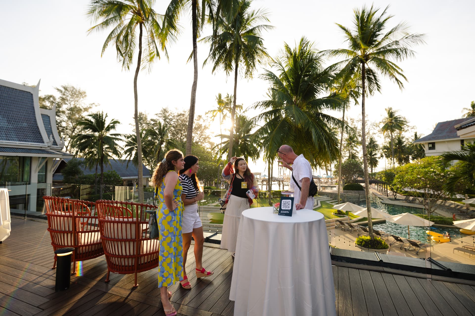 Retreat guests at sunset drinks by the pool in Koh Lanta