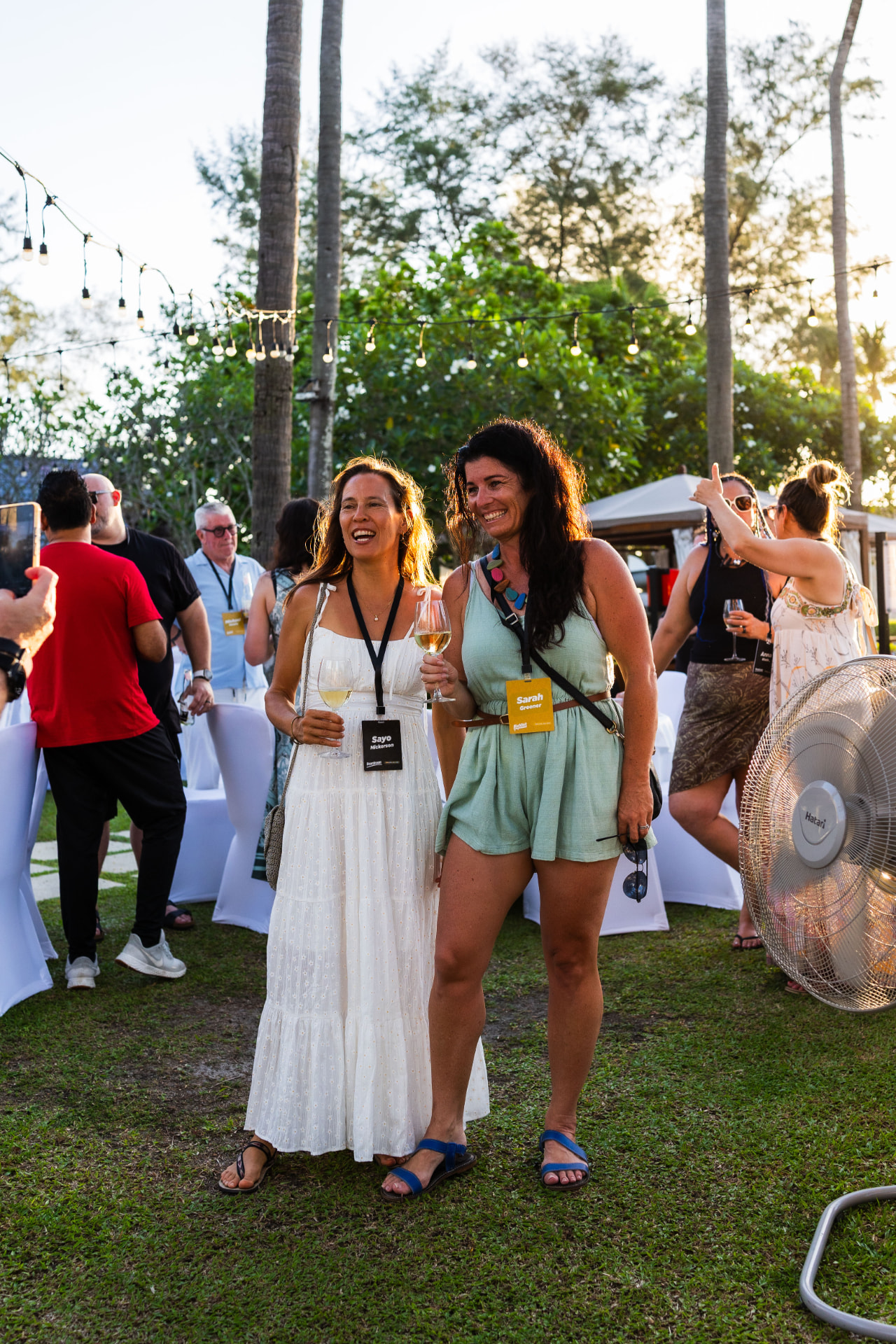 Two women laughing together at the Koh Lanta retreat evening gathering