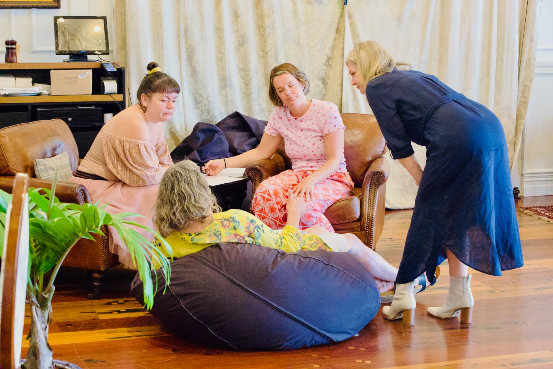 Four women in a small group discussion in armchairs at the Russell retreat
